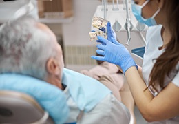 Dental team member speaking to patient during consultation