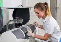 Dental team member preparing CEREC milling unit