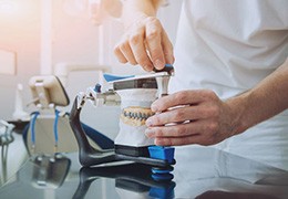 Dental lab technician working with an articulator