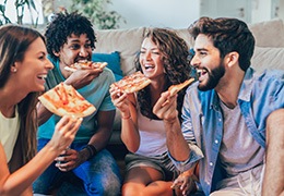 Group of friends eating pizza together