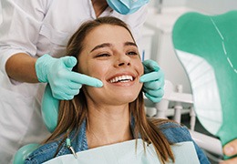 Dental patient looking at her smile in mirror