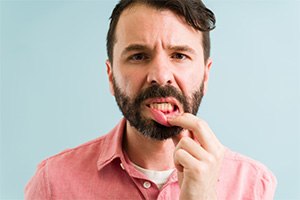 Patient pointing to inflamed gums