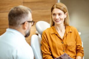 Dentist and patient talking during dental implant consultation