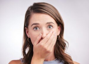 Concerned woman covering her mouth